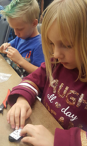 Two young kids working on electronic projects